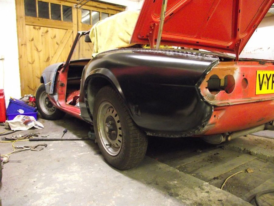 Triumph sports car mid-restoration in the shop